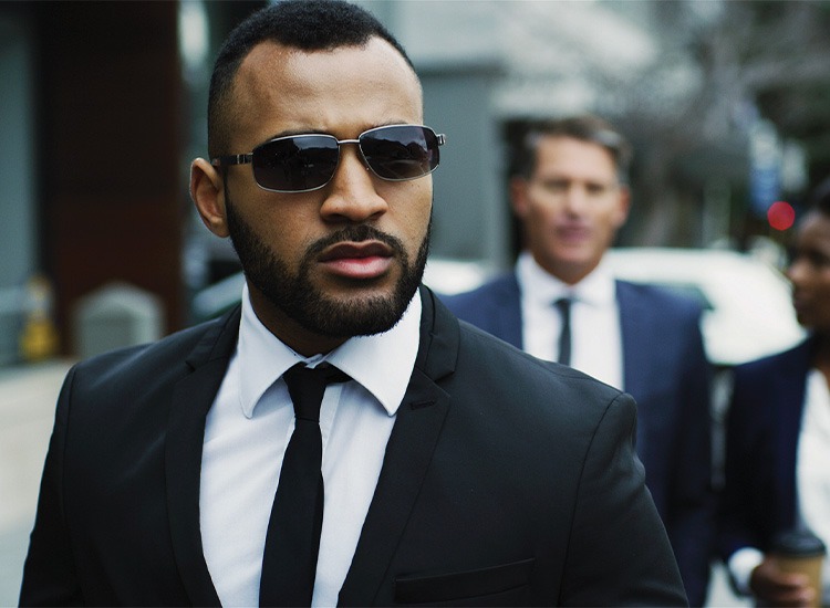 Private close-protection officer escorting a client