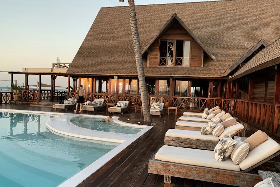 Resort with pool and loungers at sunset