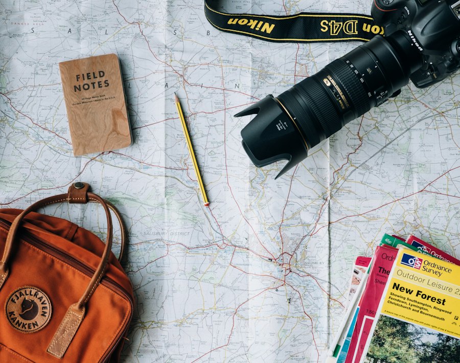 Map, camera and notebook laid out for planning a trip